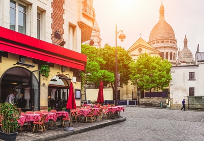 Cozy street with tables of cafe in quarter Montmartre in Paris, France