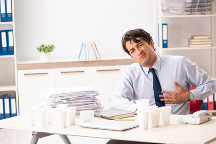 Young employee addicted to coffee