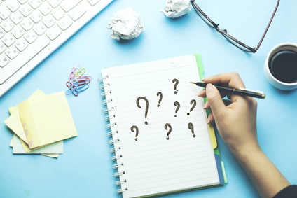 woman written question mark on notepad